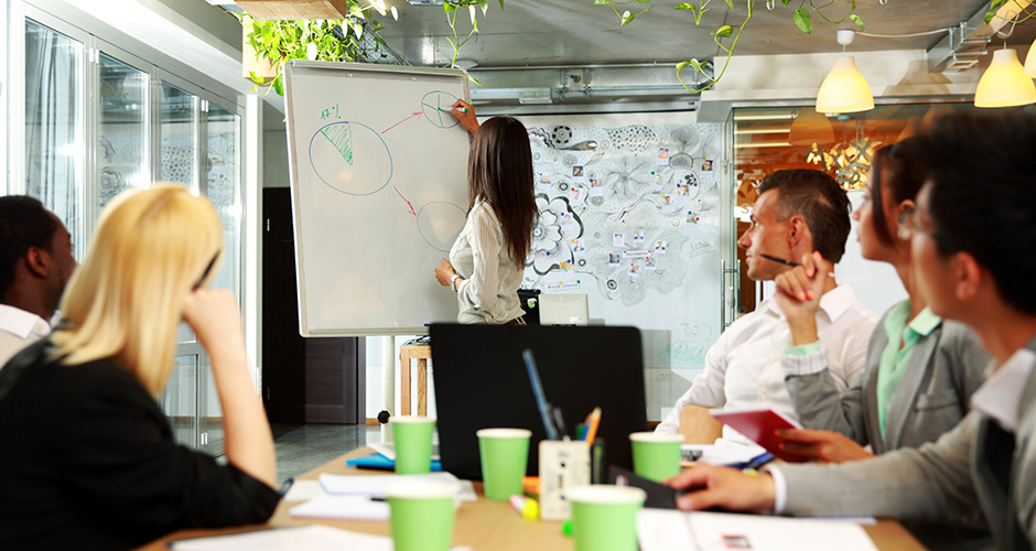 Businesswoman explaining graph to his colleagues